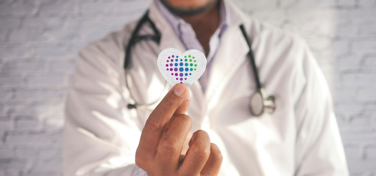 doctor holds lifepoint heart logo in front of the camera