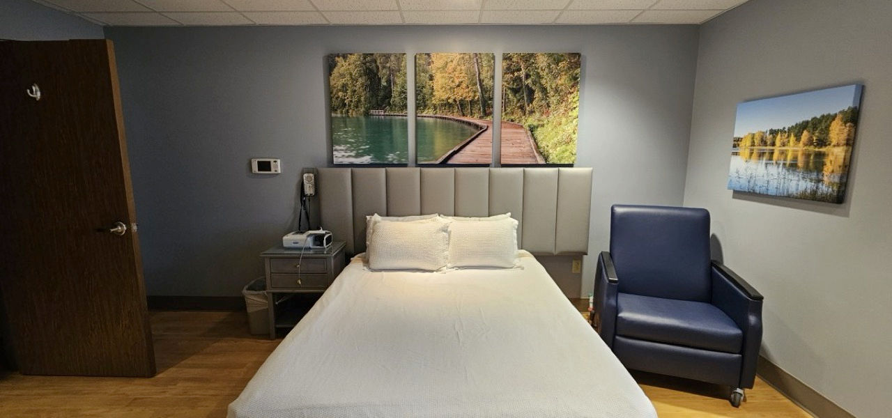 A bed with a recliner and headboard