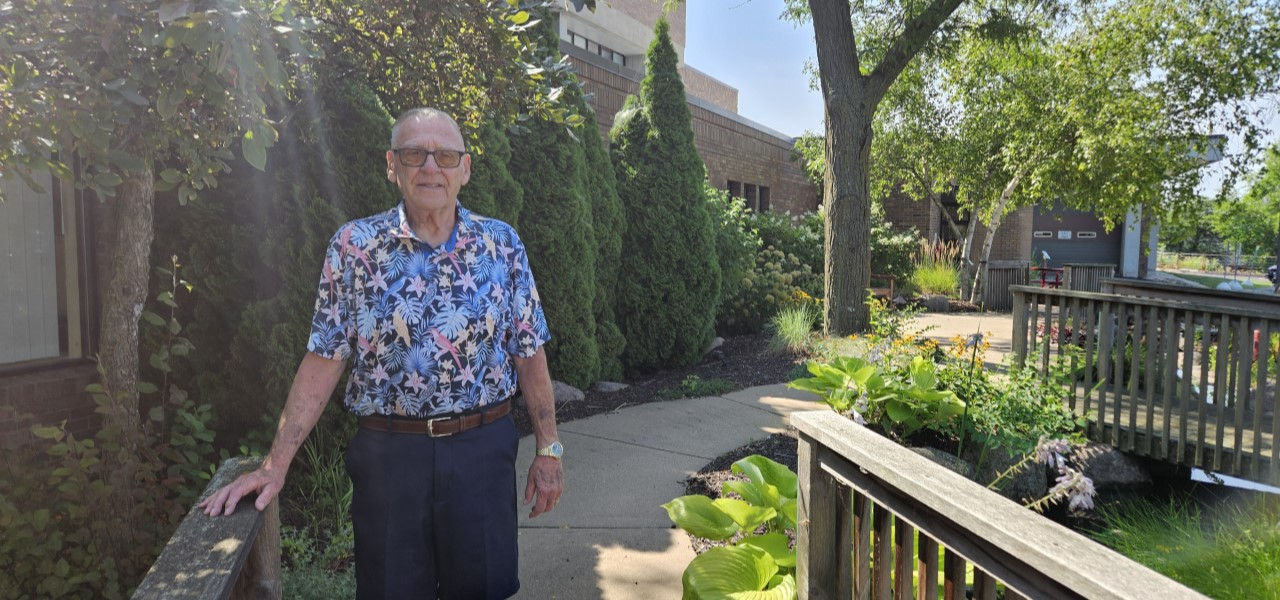 Gary L Watertown Patient standing on bridge in garden