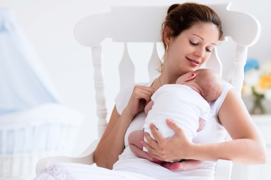 Mother holds baby on her chest